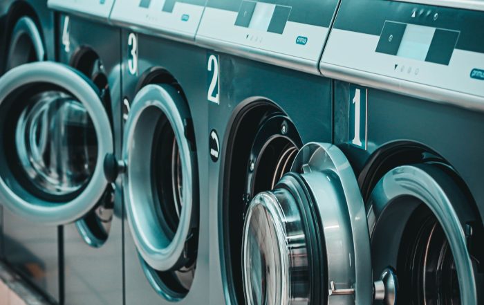 a row of coin laundry machines - Post Featured Image